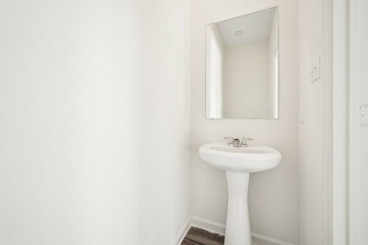 9349 Beryl Lane Conroe, TX 77303 - Photo 8 of 9 a bathroom with a sink and a mirror