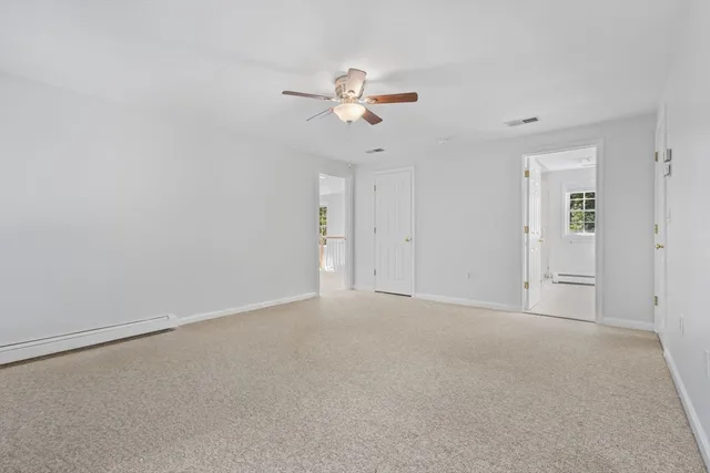 a view of empty room with a ceiling fan