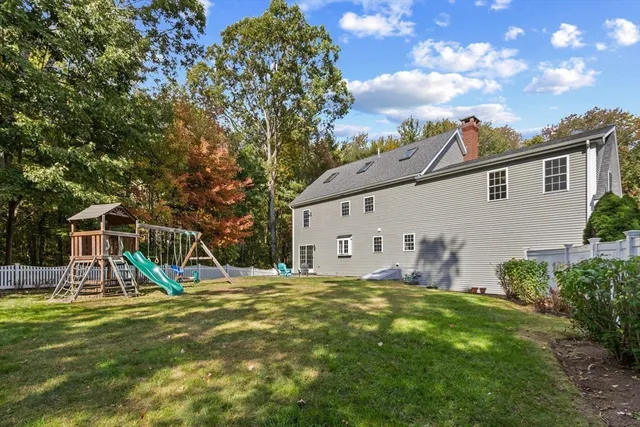 a backyard of a house with table and chairs