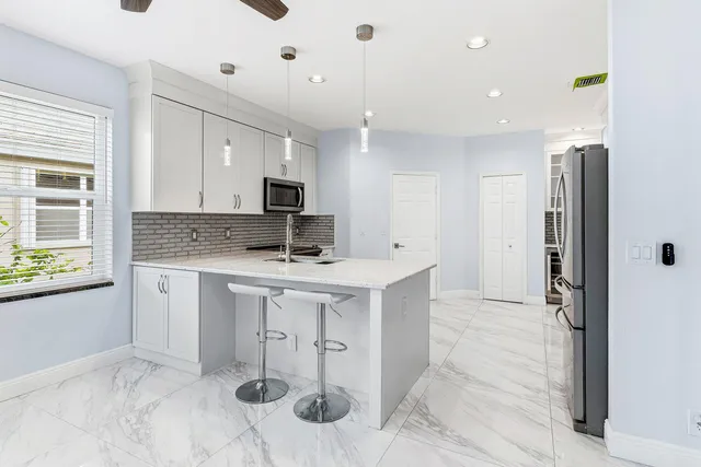 a bathroom with a bathtub shower sink vanity and mirror