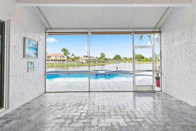 a view of a swimming pool with a garden and outdoor seating