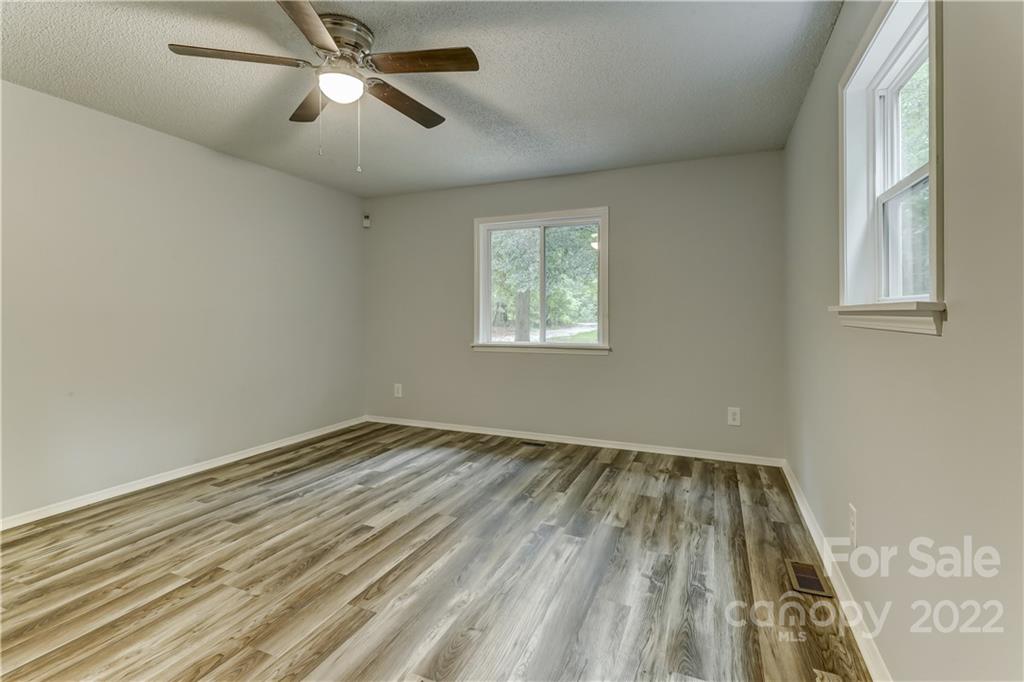 2050 Haire Road Fort Mill, SC 29715 - Photo 18 of 34 a view of empty room with wooden floor and fan
