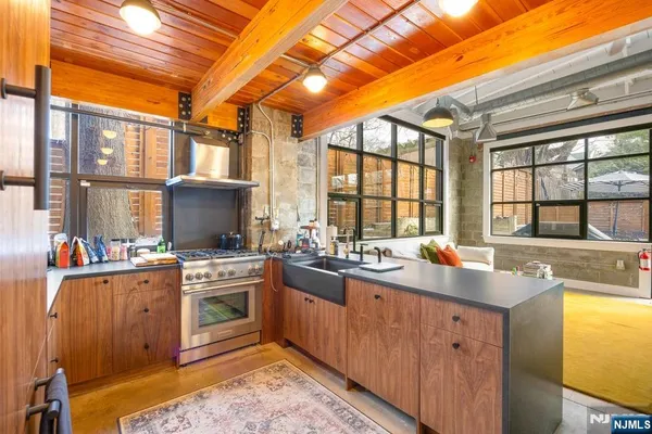 a kitchen with a sink stove and cabinets