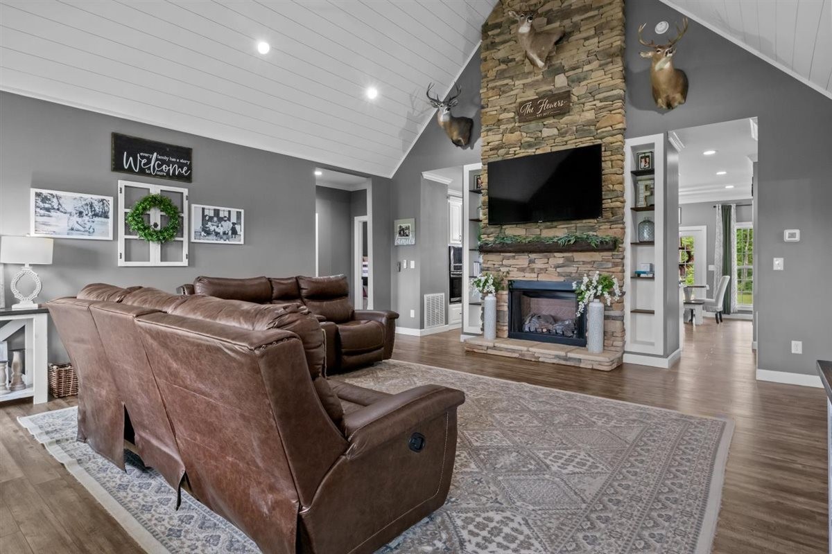 3571 Old Blacktop Road McEwen, TN 37101 - Photo 15 of 99 a living room with furniture a flat screen tv and a fireplace
