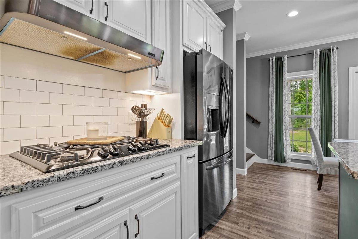 3571 Old Blacktop Road McEwen, TN 37101 - Photo 22 of 99 a kitchen with granite countertop a stove and a refrigerator