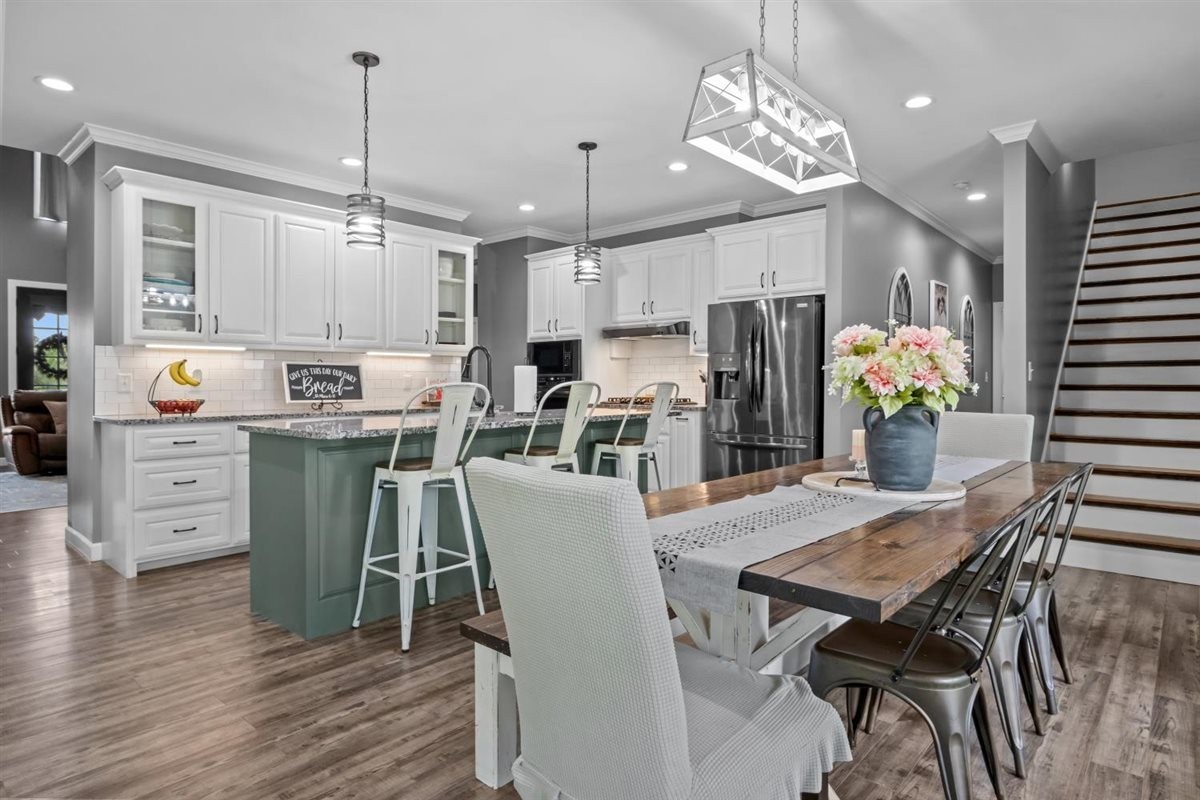 3571 Old Blacktop Road McEwen, TN 37101 - Photo 24 of 99 a kitchen with stainless steel appliances kitchen island granite countertop a dining table chairs refrigerator and sink