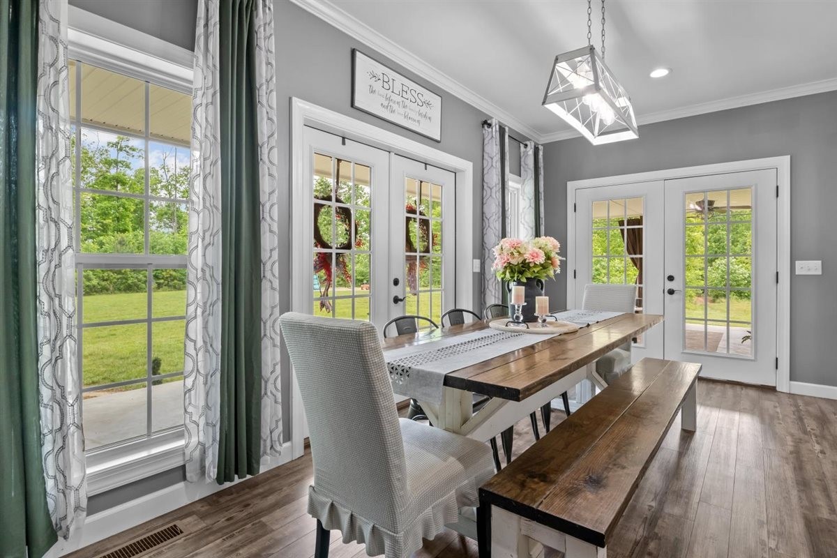 3571 Old Blacktop Road McEwen, TN 37101 - Photo 25 of 99 a view of a dining room with furniture a chandelier and wooden floor