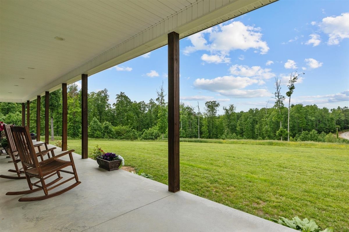 3571 Old Blacktop Road McEwen, TN 37101 - Photo 3 of 99 a view of a patio with a table chairs potted plants and a big yard