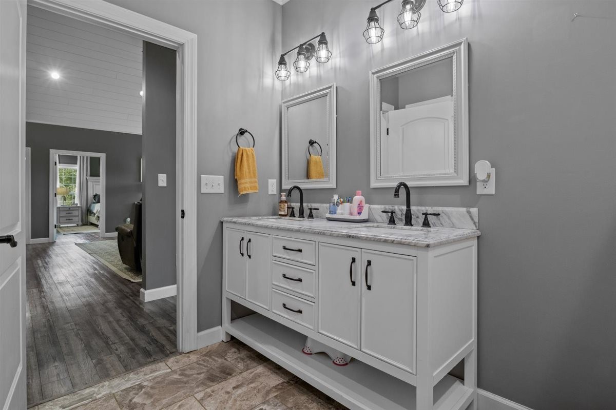 3571 Old Blacktop Road McEwen, TN 37101 - Photo 37 of 99 a bathroom with a double vanity sink and a mirror
