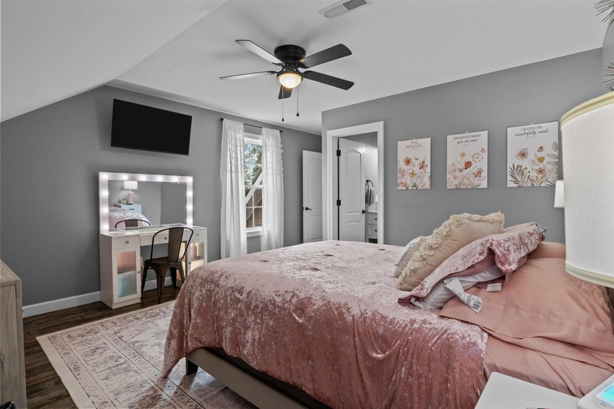 3571 Old Blacktop Road McEwen, TN 37101 - Photo 44 of 99 a bedroom with a large bed a chandelier and dresser