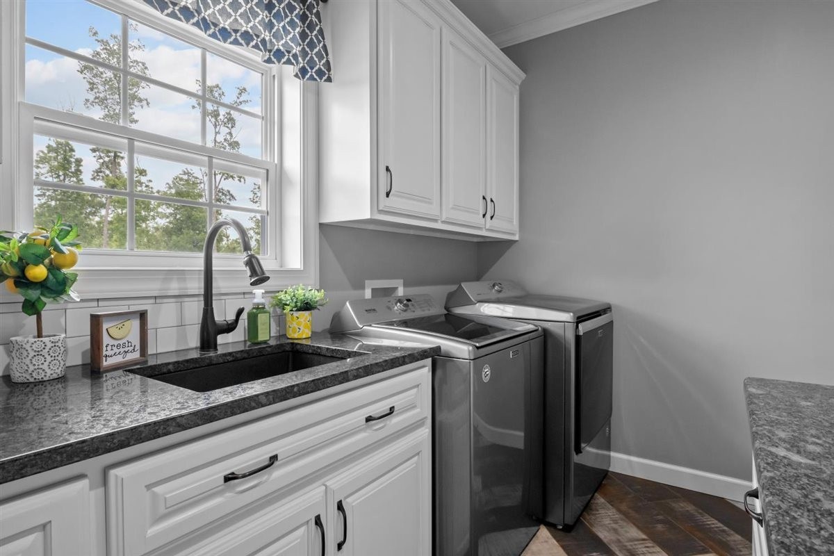 3571 Old Blacktop Road McEwen, TN 37101 - Photo 48 of 99 a kitchen with stainless steel appliances granite countertop white cabinets a potted plant and a window