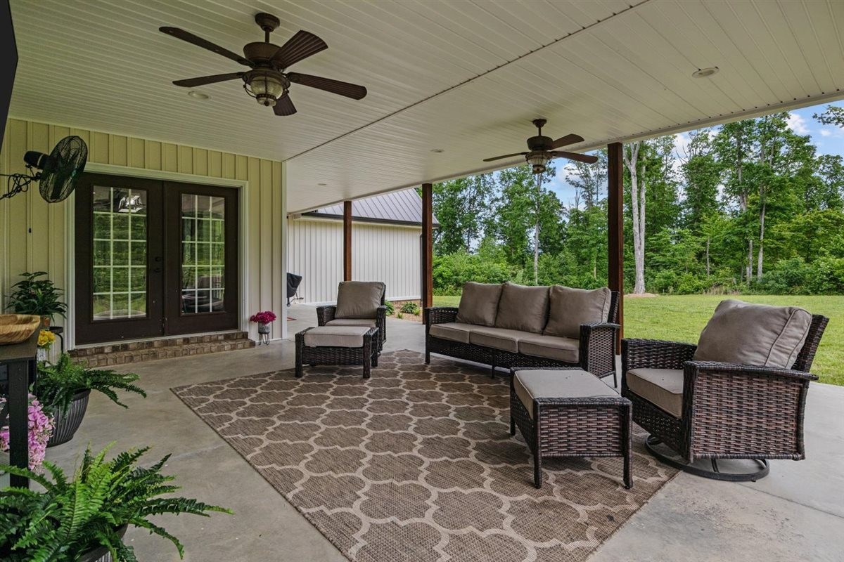 3571 Old Blacktop Road McEwen, TN 37101 - Photo 56 of 99 a living room with patio furniture and a floor to ceiling window
