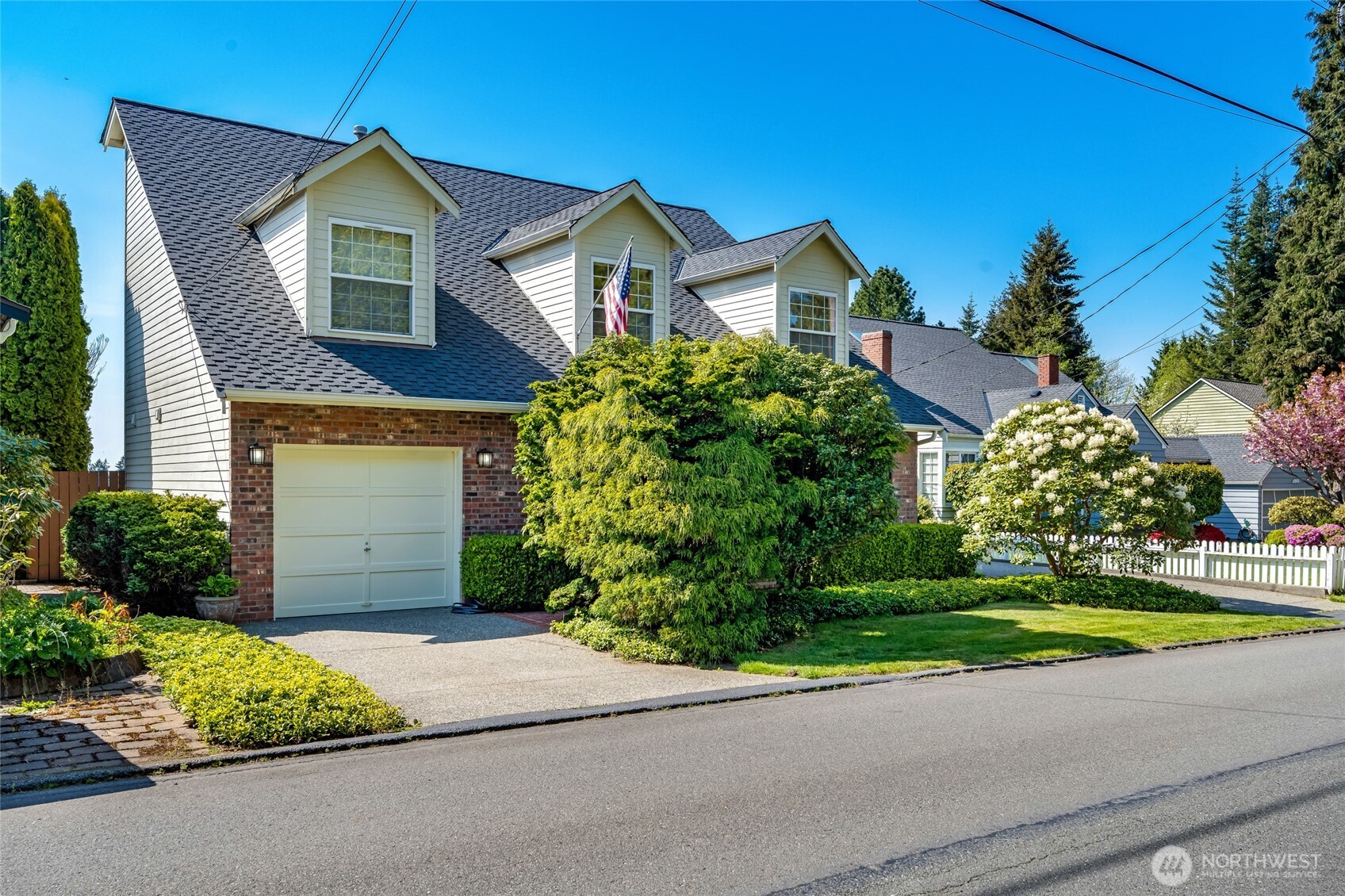 4920 Seahurst Avenue Everett, WA 98203 - Photo 4 of 39 a front view of a house with a yard and garage