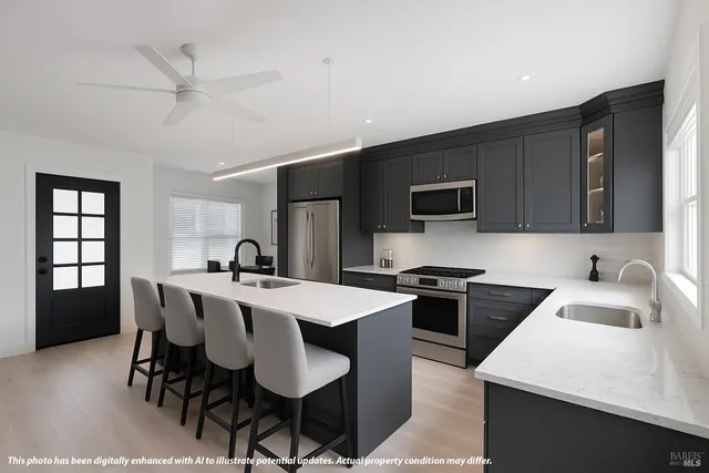 a kitchen with stainless steel appliances a table chairs and a refrigerator