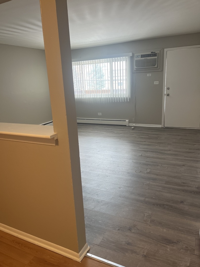 8817 South Roberts Road, Unit 7 Hickory Hills, IL 60457 - Photo 4 of 9 an empty room with windows