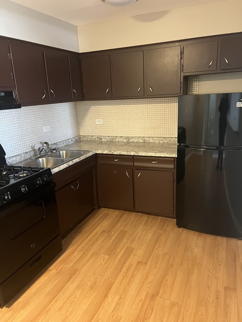 8817 South Roberts Road, Unit 7 Hickory Hills, IL 60457 - Photo 7 of 9 a kitchen with a sink and cabinets