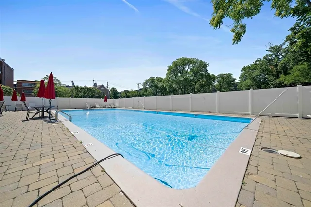 a backyard of a house with barbeque oven table and chairs
