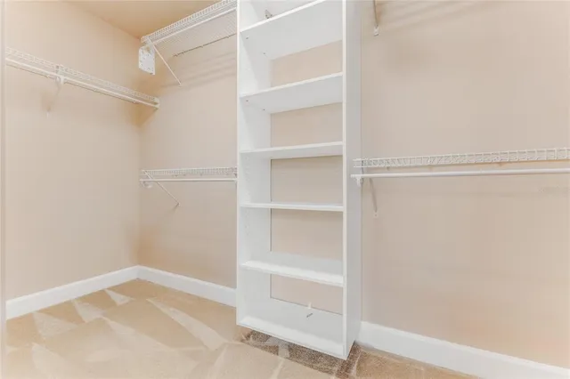 a spacious bathroom with a tub and large windows