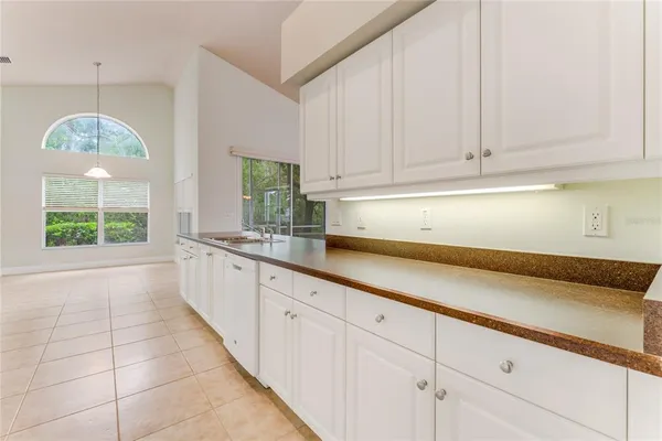 a view of a kitchen with a sink and a refrigerator