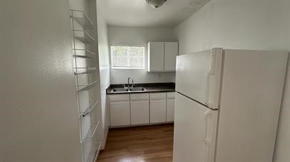 5611 Jackson Street, Unit 11 Houston, TX 77004 - Photo 4 of 7 a kitchen with a refrigerator and a stove top oven