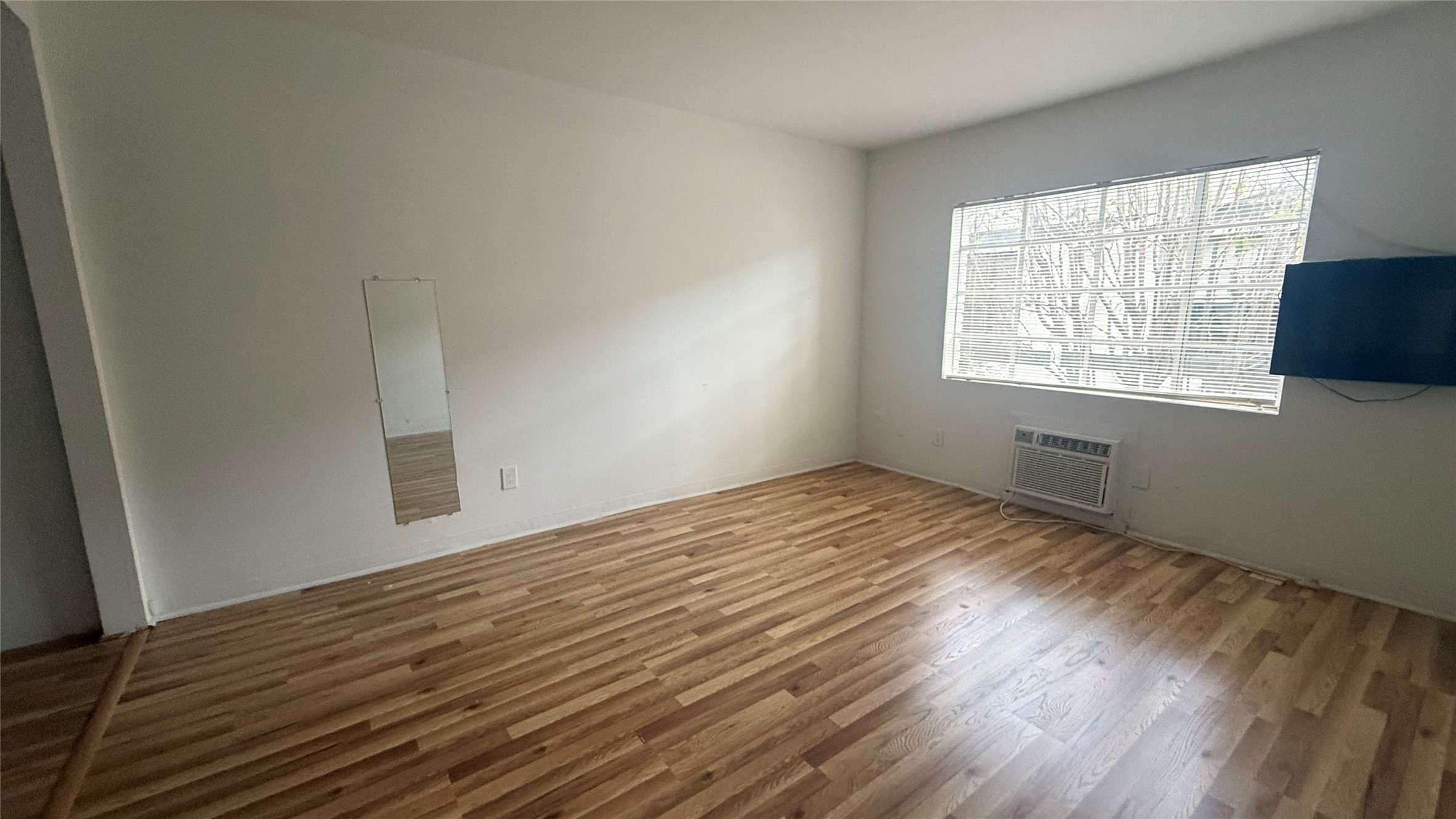 5611 Jackson Street, Unit 11 Houston, TX 77004 - Photo 6 of 7 a view of empty room with wooden floor and fan