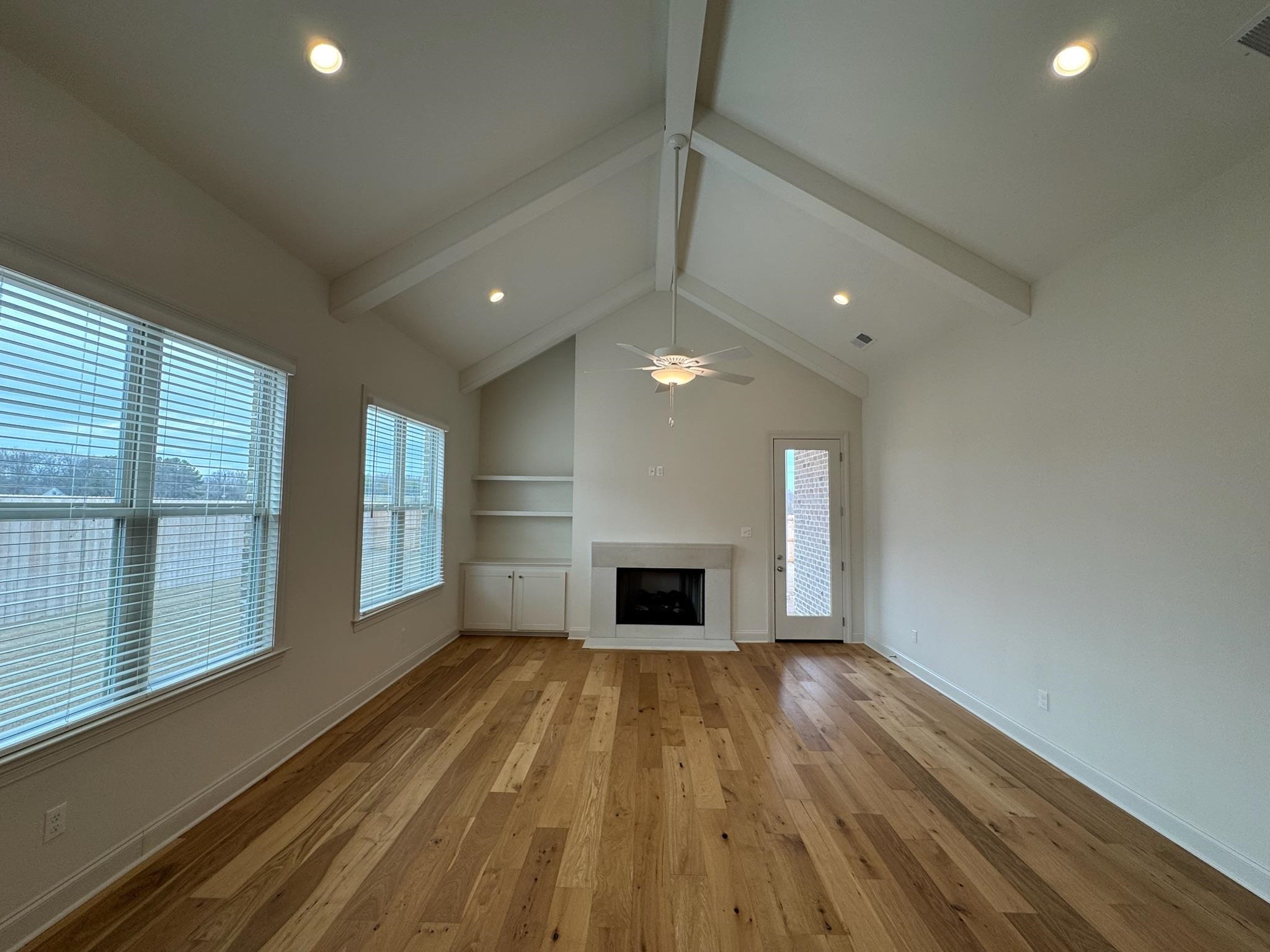 11512 Sunsparkler Way Collierville, TN 38017 - Photo 10 of 40 Unfurnished living room with a fireplace, light wood-style flooring, recessed lighting, and ceiling fan