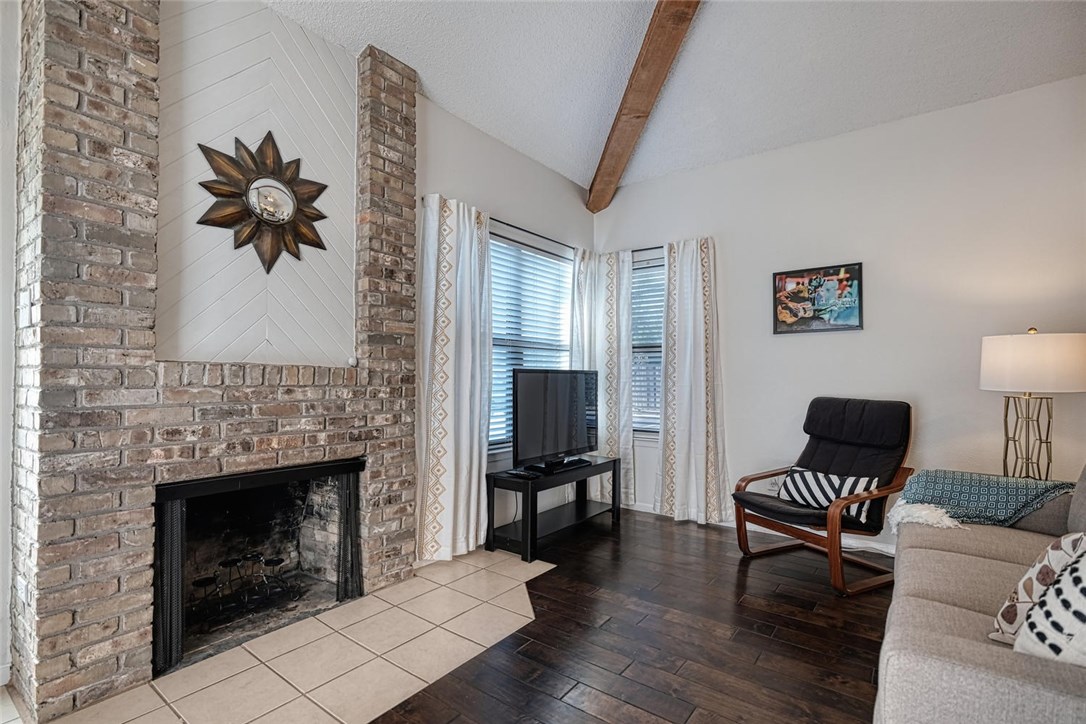 1748 Ohlen Road, Unit 74 Austin, TX 78757 - Photo 3 of 15 a living room with furniture and a fireplace