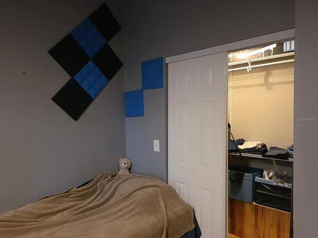 a bedroom with a bed and cabinets