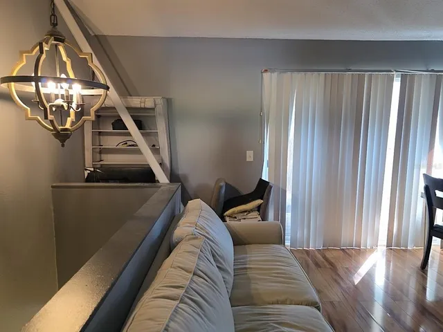 a view of a livingroom with furniture and staircase