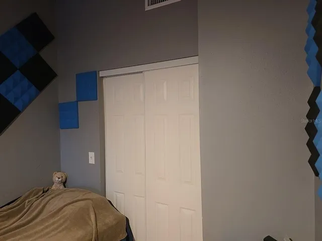 a bedroom with a bed and a cabinets