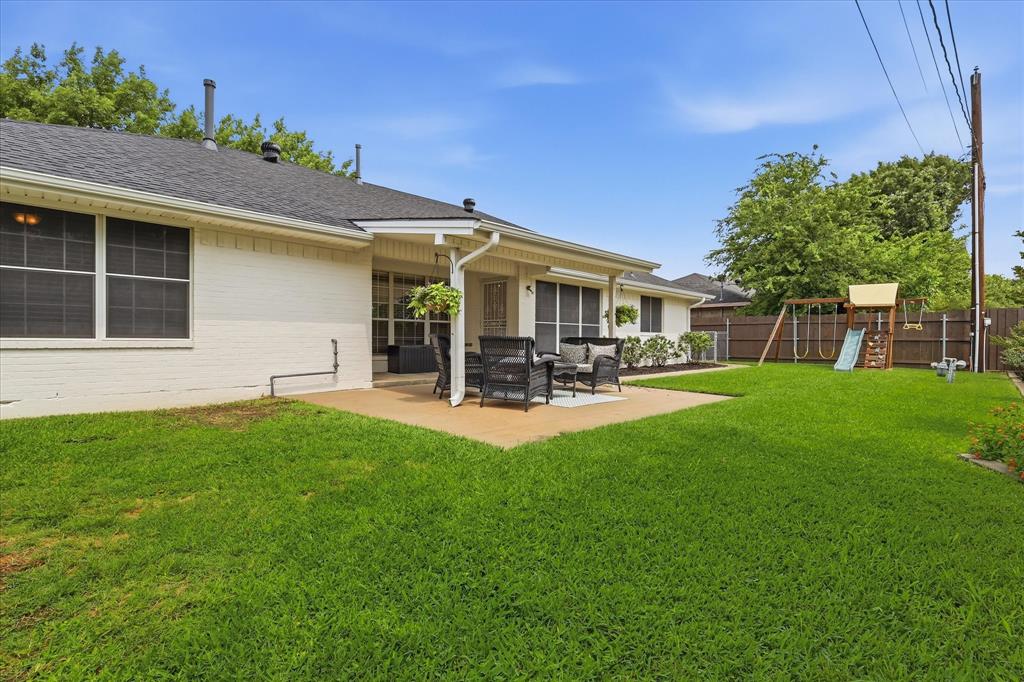 202 Colonial Heights Sanger, TX 76266 - Photo 24 of 27 a view of a patio with table and chairs with a yard