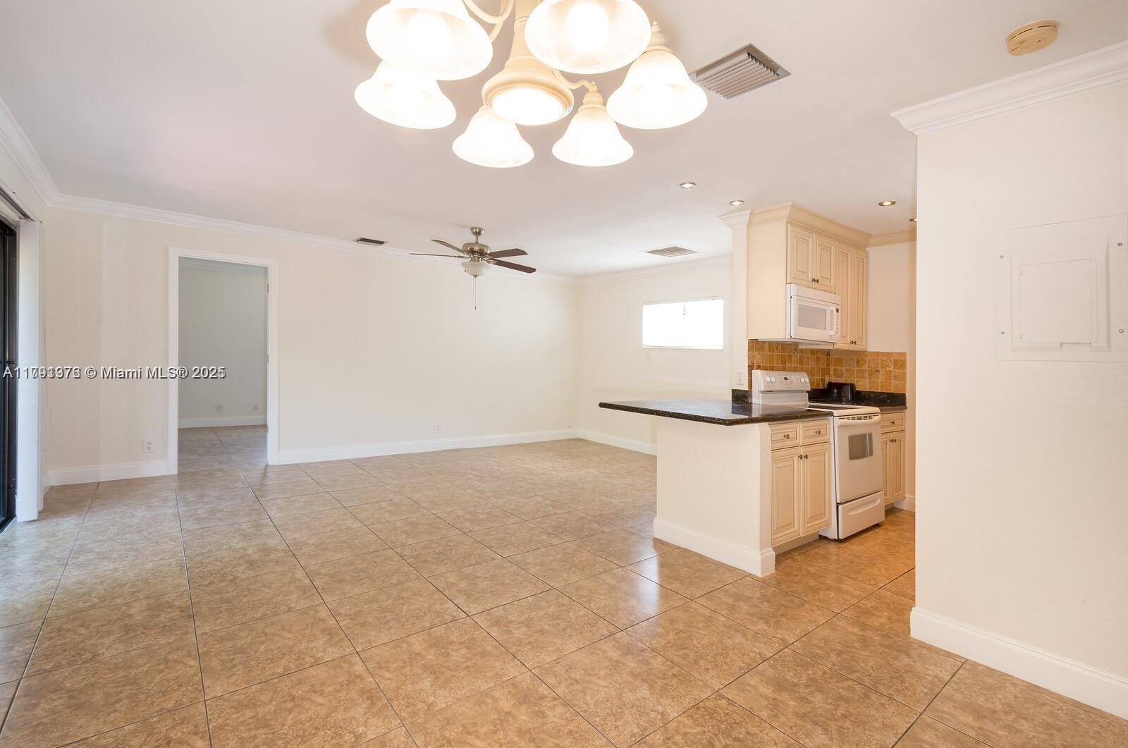 1 Crossings Circle, Unit E Boynton Beach, FL 33435 - Photo 2 of 14 a view of kitchen with refrigerator and cabinets
