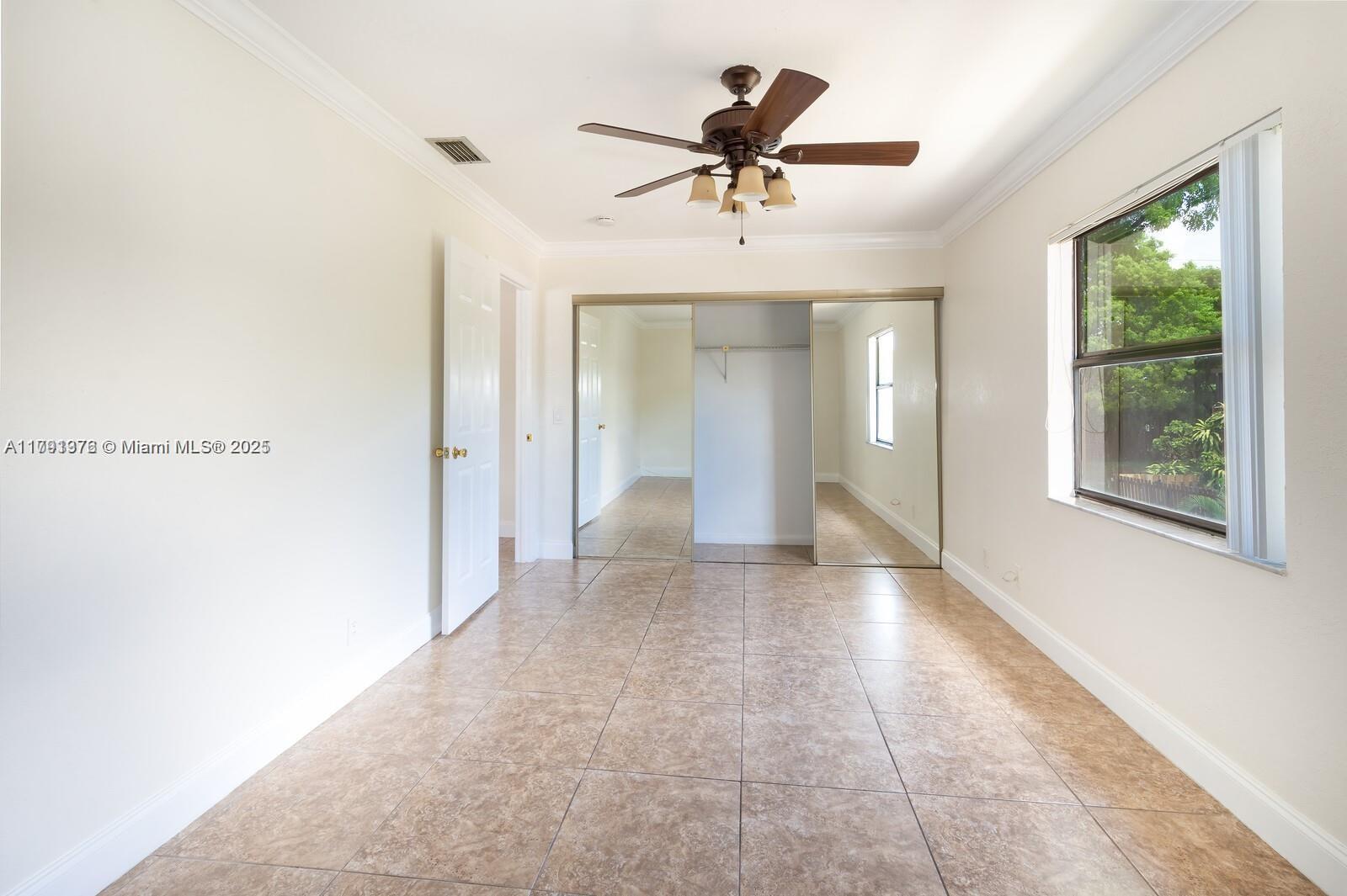 1 Crossings Circle, Unit E Boynton Beach, FL 33435 - Photo 7 of 14 a view of a livingroom with a ceiling fan and window