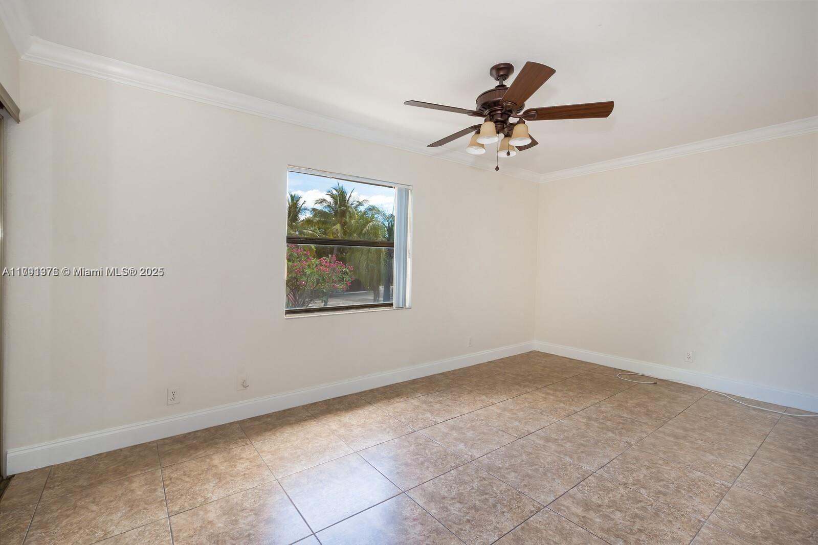 1 Crossings Circle, Unit E Boynton Beach, FL 33435 - Photo 8 of 14 an empty room with windows and ceiling fan view