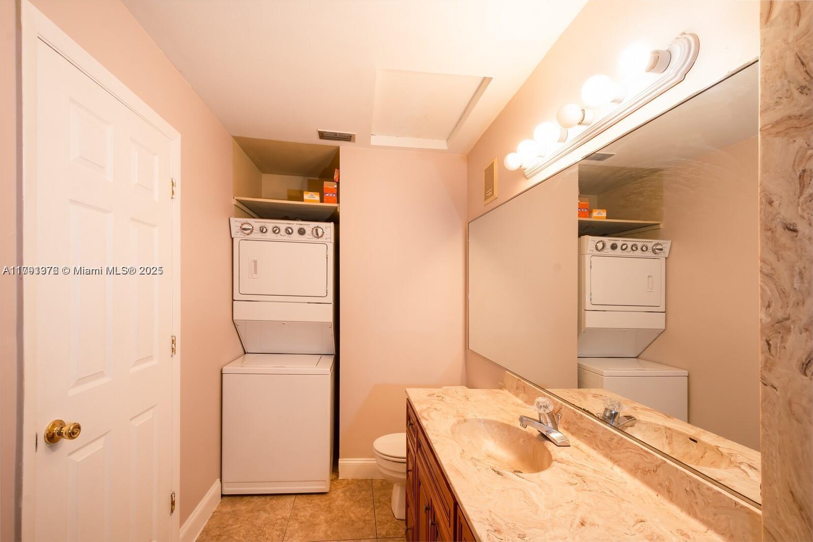 1 Crossings Circle, Unit E Boynton Beach, FL 33435 - Photo 10 of 14 a bathroom with a sink a mirror and a shower