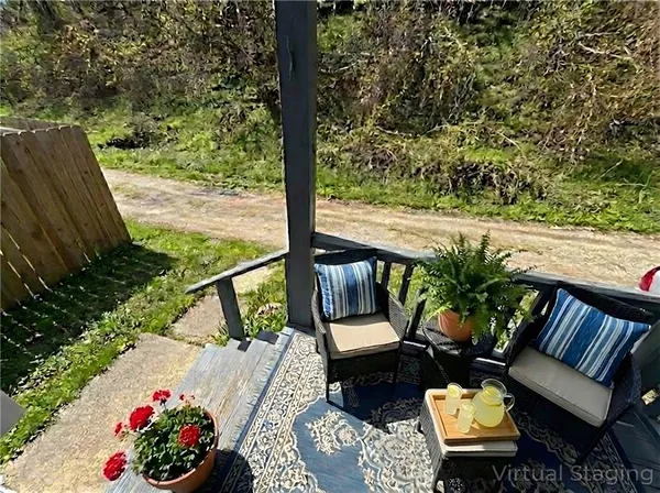 a view of a chairs and table in the balcony