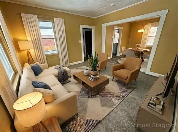 a living room with furniture and wooden floor