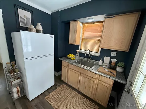 a kitchen with a refrigerator and a sink