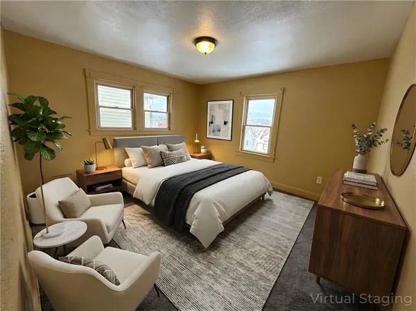 a bedroom with a bed and a couch