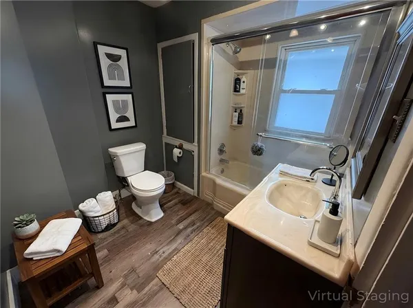 a bathroom with a sink toilet and shower