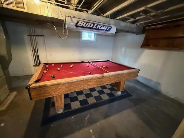 a wooden bed sitting in a room next to a window