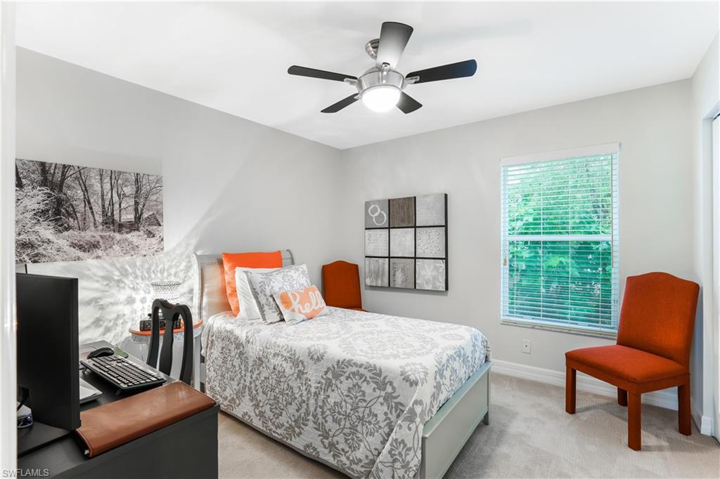 1655 Triangle Palm Terrace Naples, FL 34119 - Photo 14 of 22 a bedroom with a bed a couch and a window