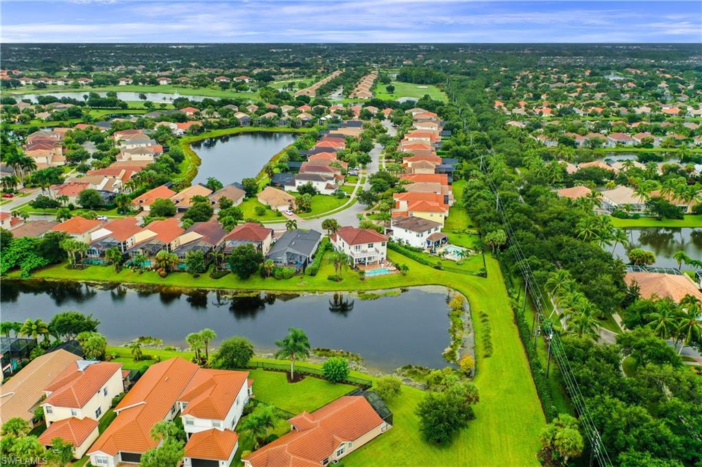 1655 Triangle Palm Terrace Naples, FL 34119 - Photo 20 of 22 an aerial view of residential houses with outdoor space and lake view