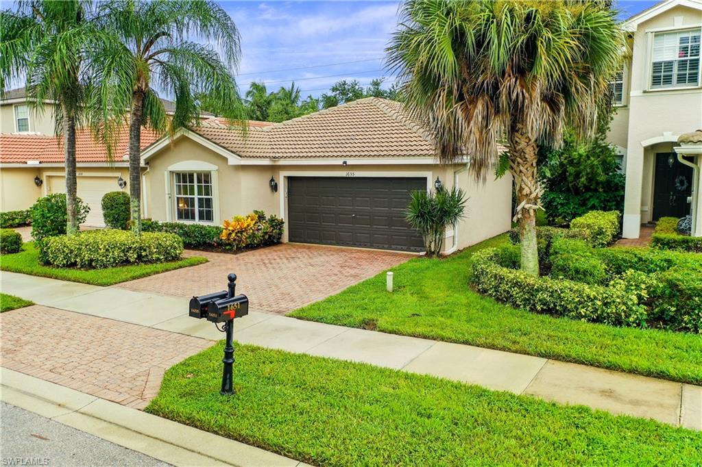 1655 Triangle Palm Terrace Naples, FL 34119 - Photo 2 of 22 a front view of a house with garden