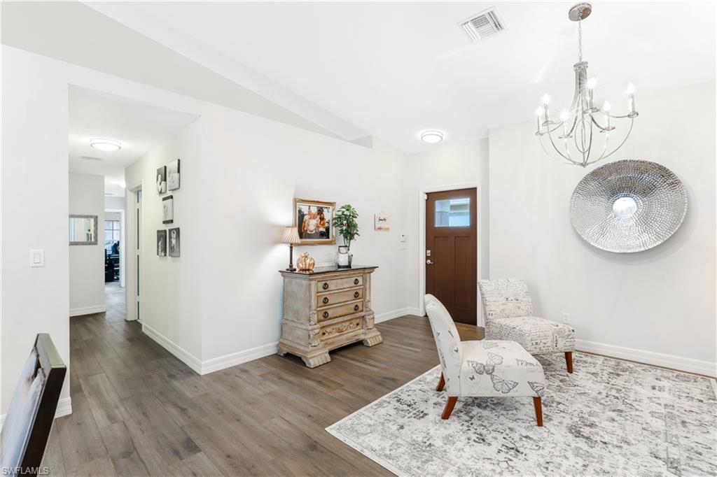 1655 Triangle Palm Terrace Naples, FL 34119 - Photo 4 of 22 a living room with furniture and wooden floor