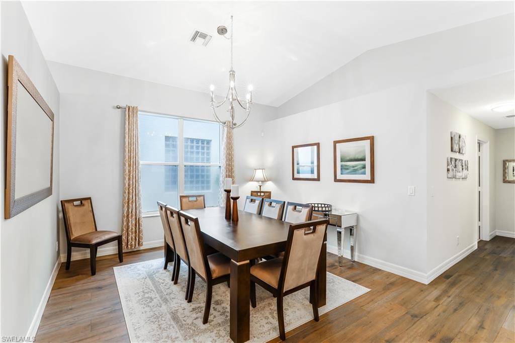 1655 Triangle Palm Terrace Naples, FL 34119 - Photo 6 of 22 a view of a dining room with furniture and wooden floor