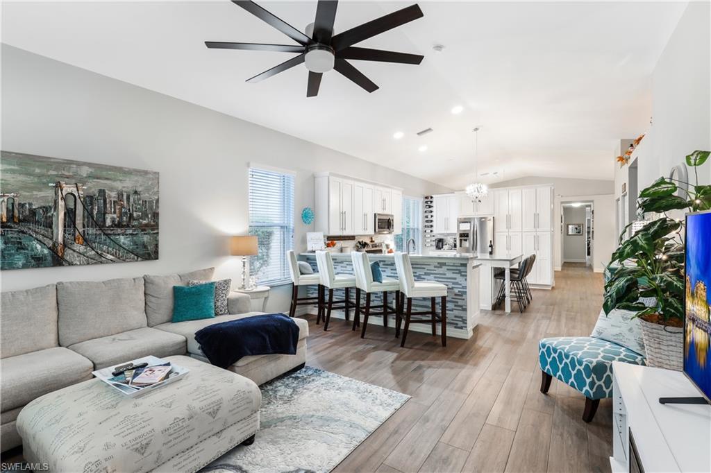1655 Triangle Palm Terrace Naples, FL 34119 - Photo 10 of 22 a living room with furniture potted plant kitchen view and a potted plant