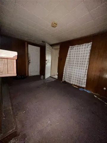 a view of an empty room with a fireplace