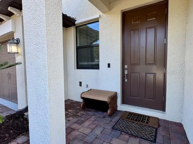 a hallway with front door wooden floor and windows