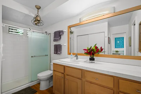 a bathroom with a sink a toilet and shower